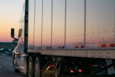 white freight truck on road during daytime